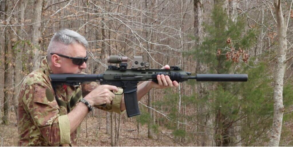 Man in camo shooting an AR-15